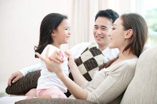 Happy Asian Family Playing with daughter in the living room